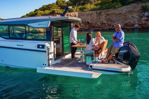 Slide: The Image of People enjoying on a 2024 Saxdor 320 GTC boat in clear turquoise water. - 8