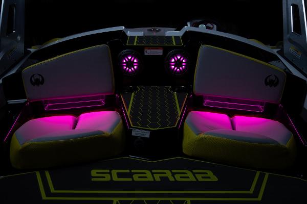 Slide: The Image of 2023 Scarab 165ID boat interior with vibrant pink LED lighting. - 19