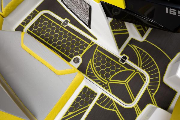 Slide: The Image of 2023 Scarab 165ID boat interior with yellow and gray seating and hexagonal pattern flooring. - 24