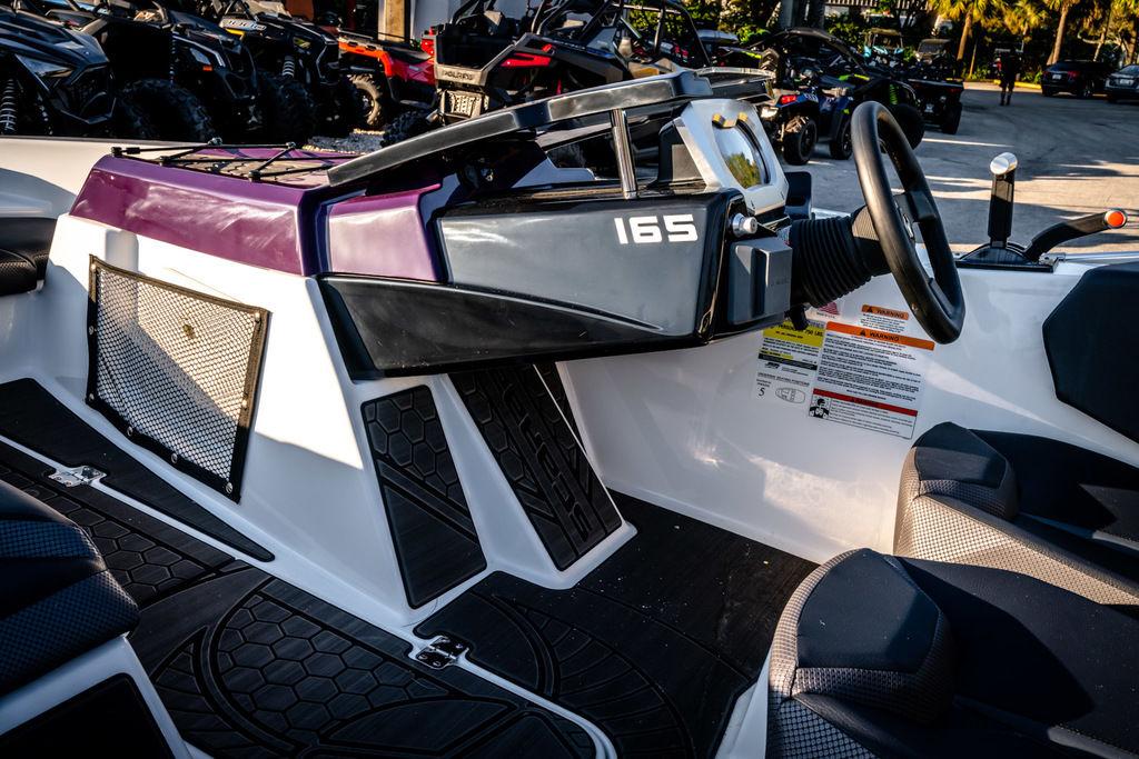 Slide: The Image of 2023 Scarab 165 ID boat interior with steering wheel and seating. - 7