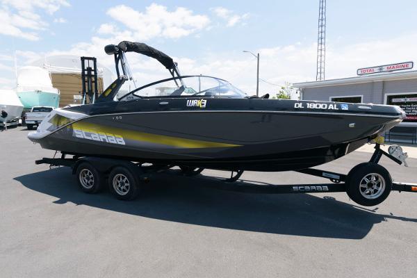Slide: The Image of 2017 Scarab 255 HO Impulse boat on trailer in marina parking lot. - 0