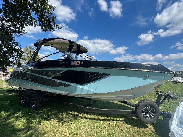 Slide: The Image of 2024 Scarab 285 ID boat on trailer under blue sky. - 11