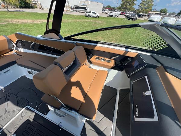 Slide: The Image of 2024 Scarab 285 ID boat interior with tan seats and modern dashboard. - 15