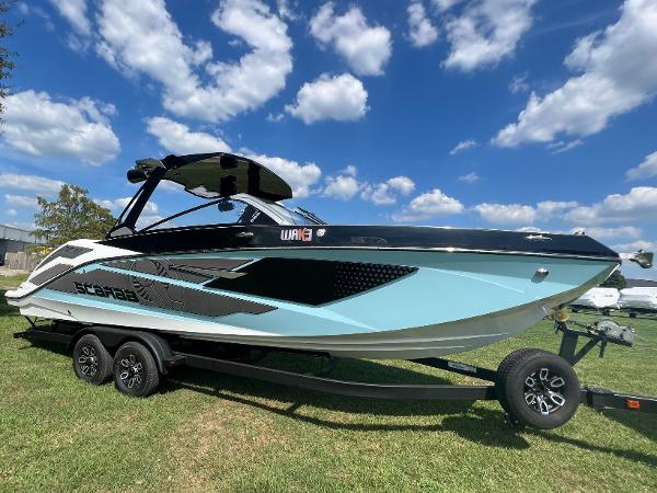 Slide: The Image of 2024 Scarab 285 ID boat on a trailer under a blue sky with clouds. - 2