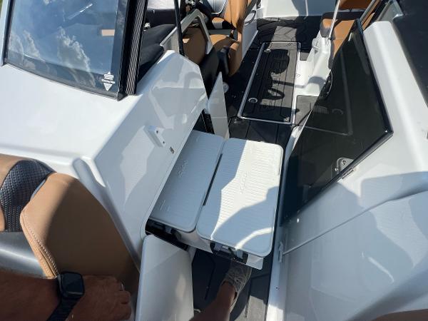 Slide: The Image of 2024 Scarab 285 ID boat interior with foldable table and seating. - 22
