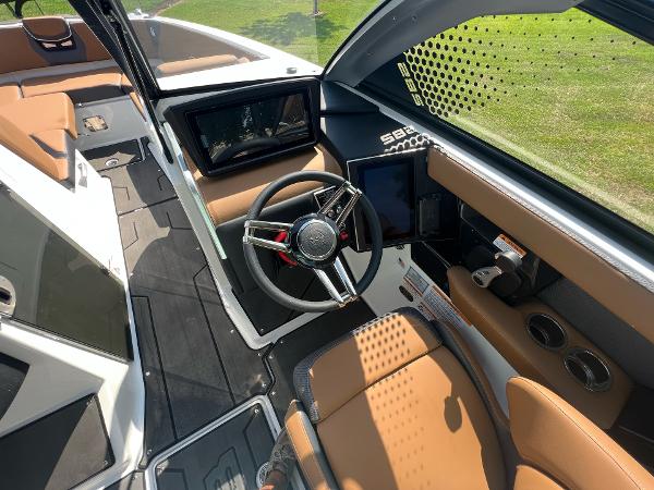 Slide: The Image of 2024 Scarab 285 ID boat cockpit with modern steering wheel and touchscreen controls. - 23