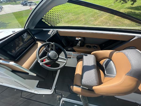 Slide: The Image of 2024 Scarab 285 ID boat cockpit with modern steering wheel and comfortable seating. - 24