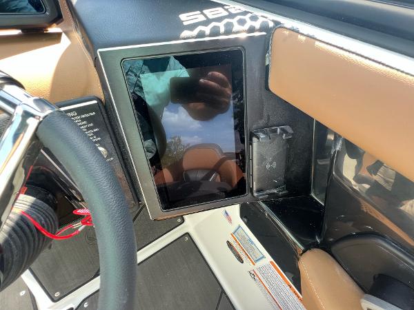 Slide: The Image of 2024 Scarab 285 ID dashboard with touchscreen display and steering wheel. - 25