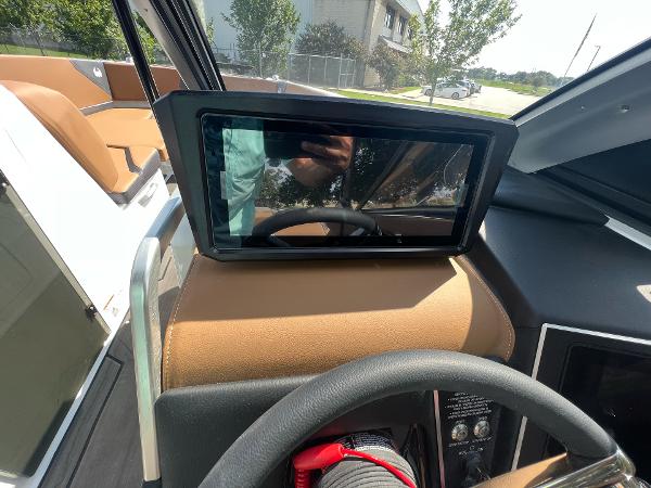 Slide: The Image of 2024 Scarab 285 ID boat dashboard with touchscreen display and steering wheel. - 26