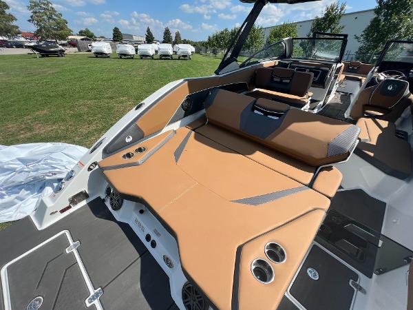 Slide: The Image of 2024 Scarab 285 ID boat interior with tan seating and cup holders. - 32