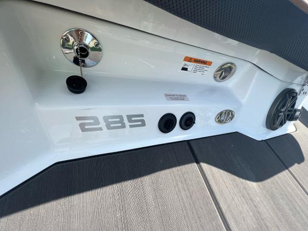 Slide: The Image of 2024 Scarab 285 ID boat rear view with model number and ports. - 33