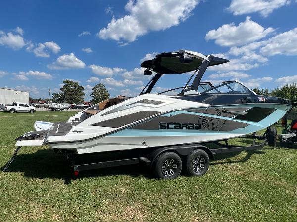 Slide: The Image of 2024 Scarab 285 ID boat on a trailer, displayed outdoors under a blue sky. - 4