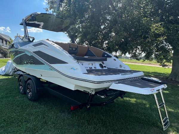 Slide: The Image of 2024 Scarab 285 ID boat on trailer, parked on grass. - 9