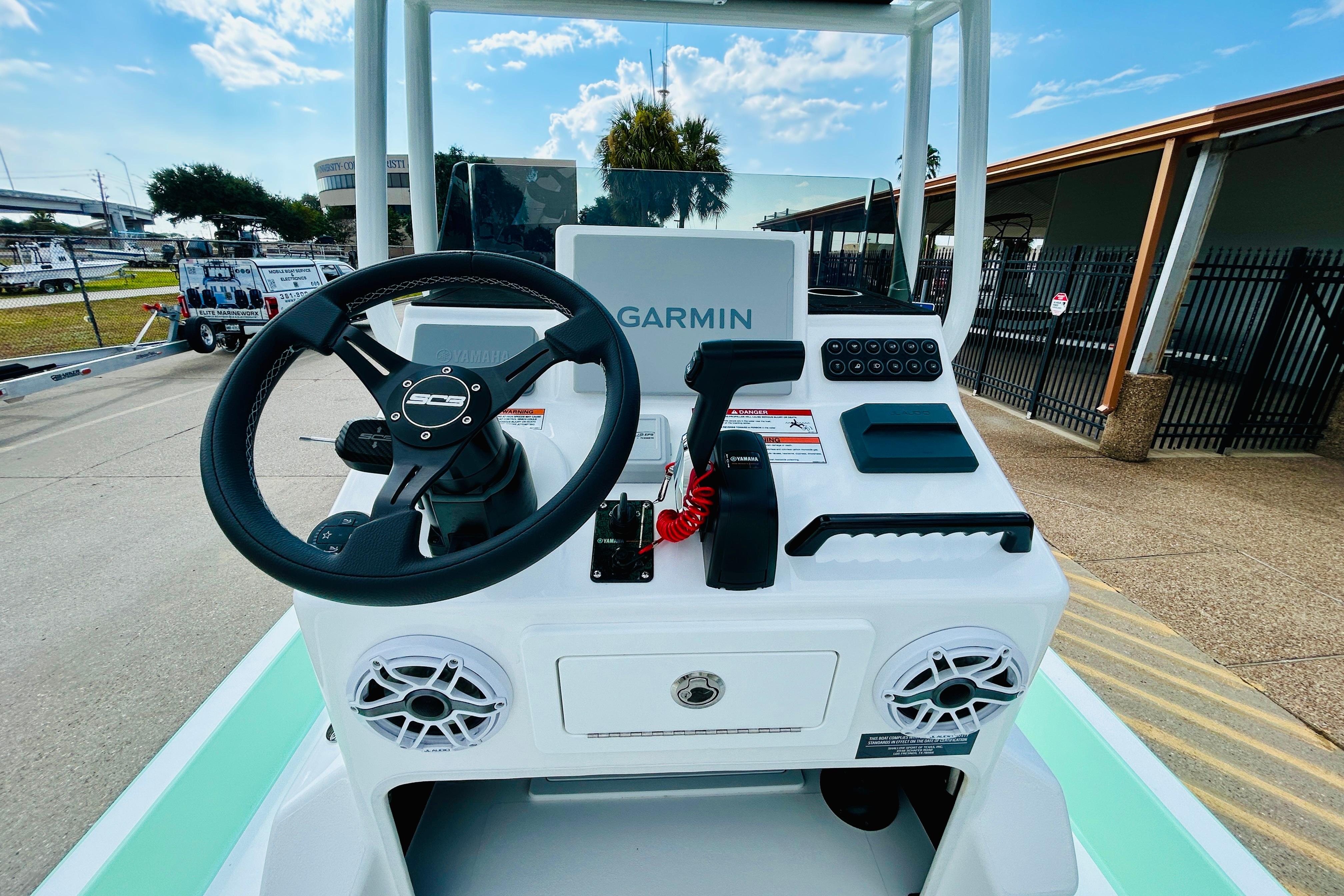 Slide: The Image of 2026 SCB R24 boat console with Garmin navigation, steering wheel, and controls. - 11