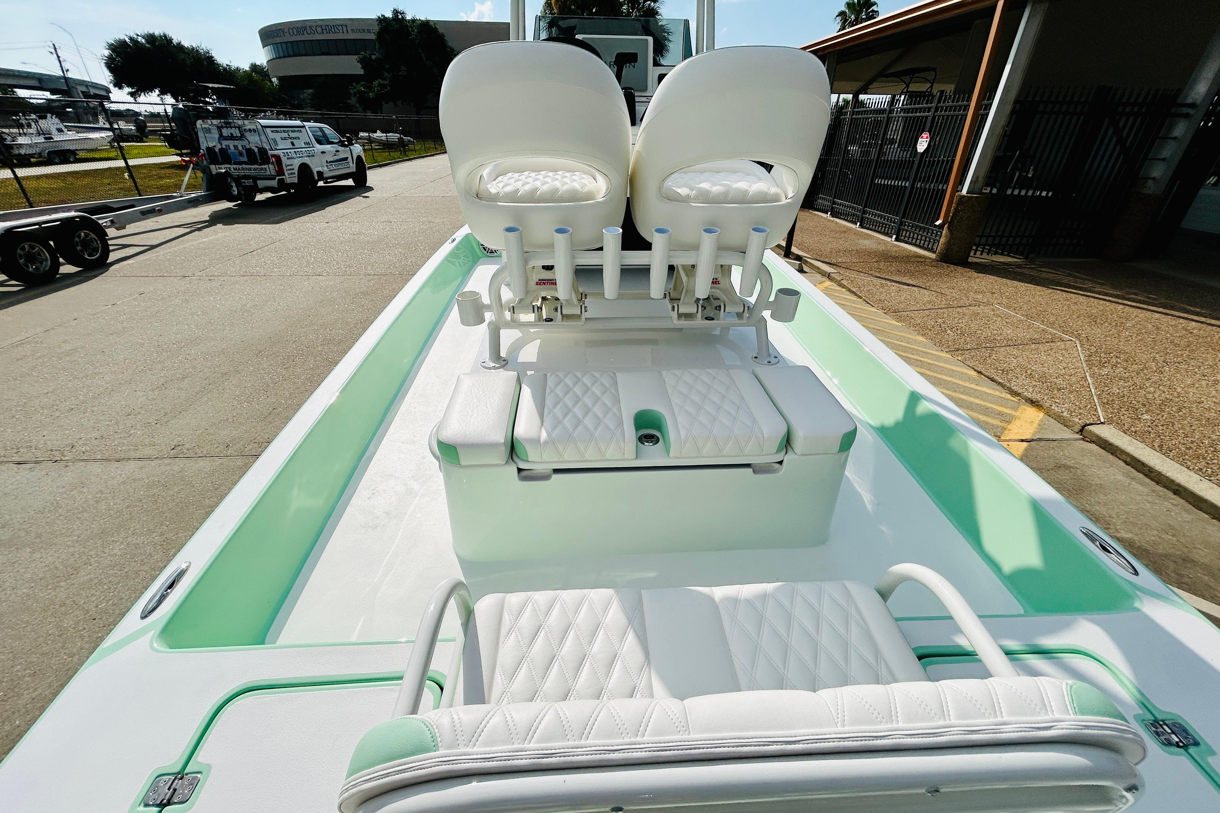 Slide: The Image of 2026 SCB R24 boat with white seating and mint green accents, parked outdoors. - 8