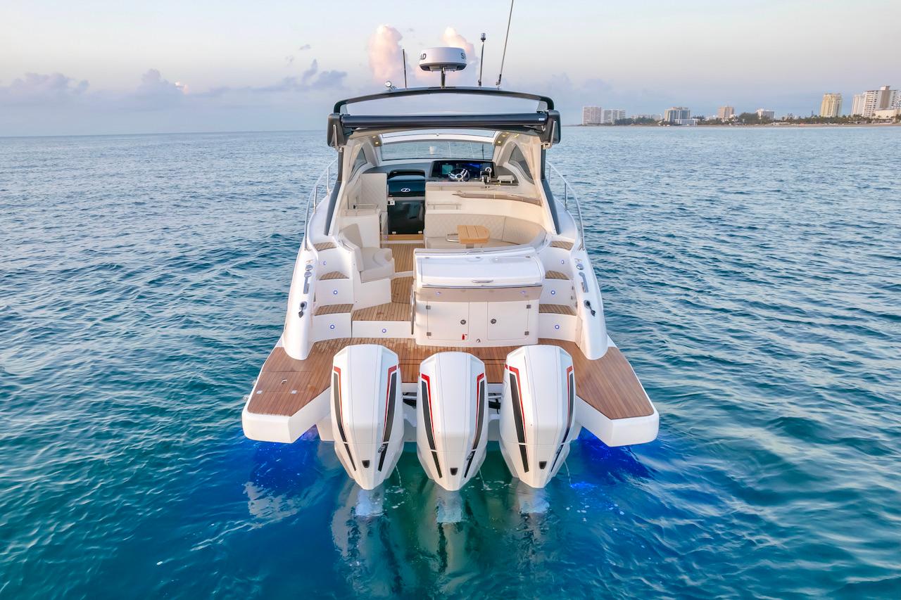 Slide: The Image of 2025 Schaefer 400 Sport yacht on open water, rear view with triple engines. - 1