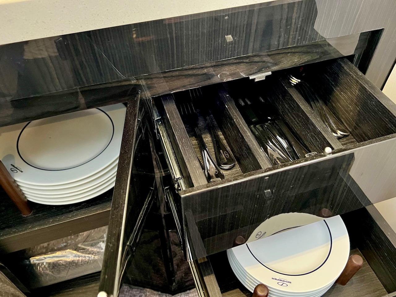 Slide: The Image of Luxury yacht kitchen with organized cutlery and plates, Schaefer 400 Sport 2025 model. - 18