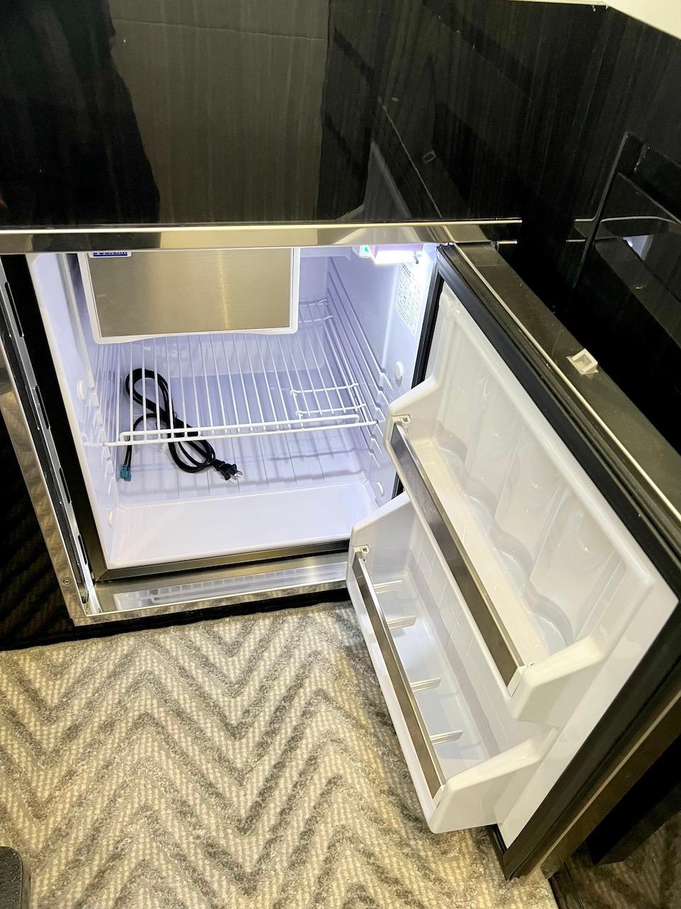 Slide: The Image of Open refrigerator inside Schaefer 400 Sport yacht, 2025 model, with empty shelves and door compartments. - 19