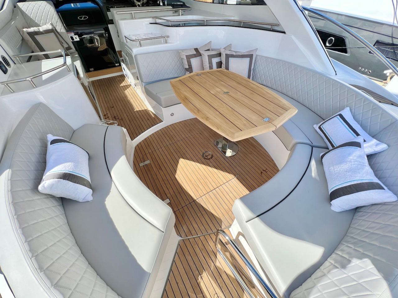 Slide: The Image of Luxurious seating area on 2025 Schaefer 400 Sport yacht with wooden table and cushions. - 33