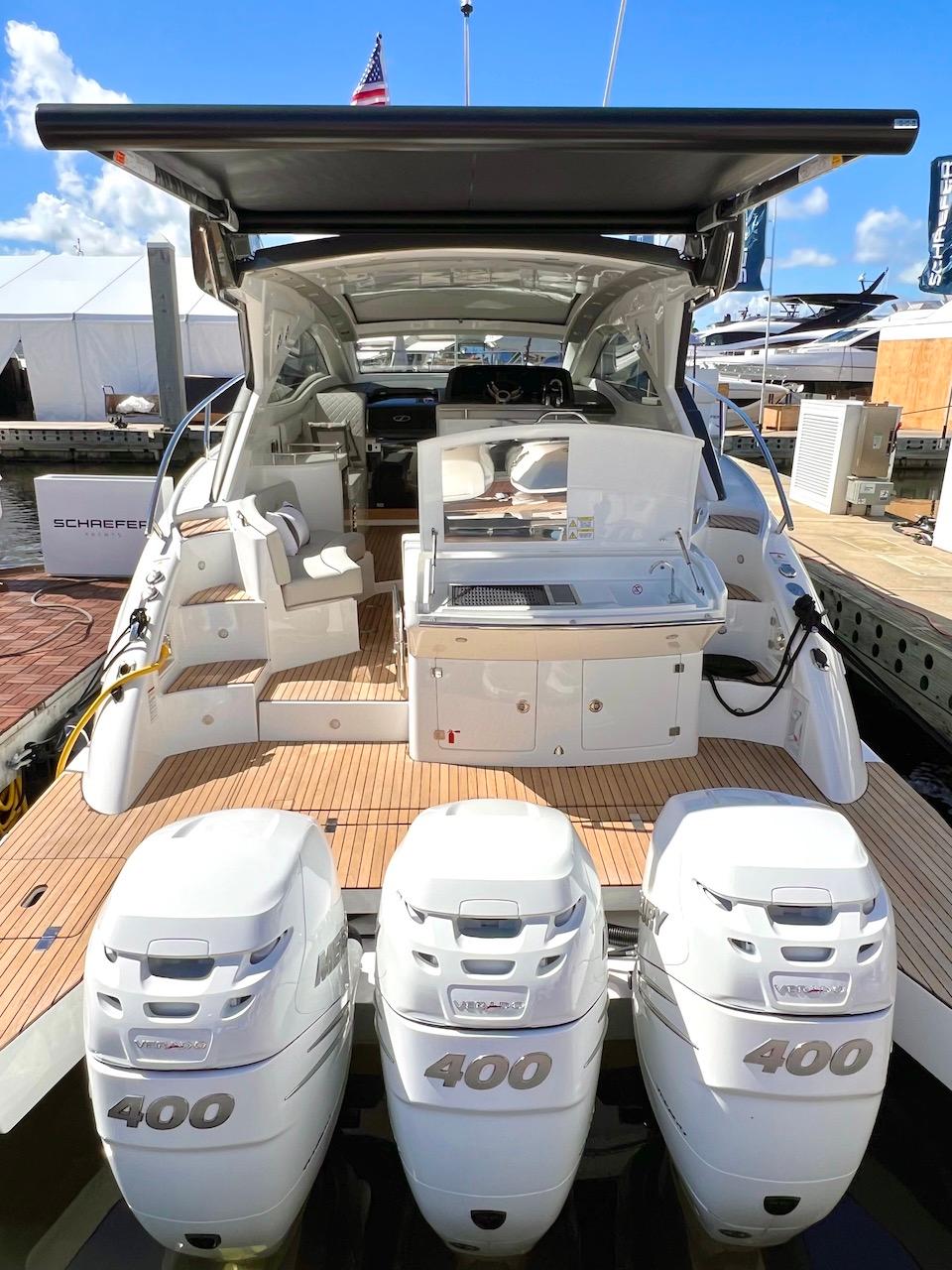 Slide: The Image of 2025 Schaefer 400 Sport yacht with triple 400 horsepower engines, docked under clear skies. - 36