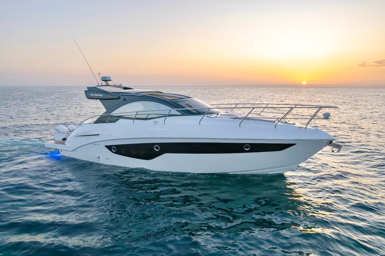 Slide: The Image of 2025 Schaefer 400 Sport yacht cruising at sunset on the ocean. - 4