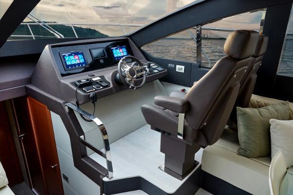 Slide: The Image of 2024 Schaefer 600 yacht cockpit with modern navigation system and luxurious seating. - 18