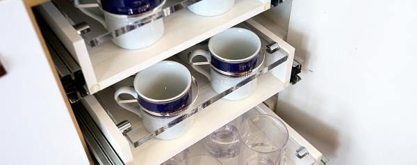 Slide: The Image of Schaefer 600 model 2024 kitchen cabinet with organized cups and glasses. - 19