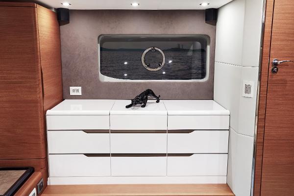 Slide: The Image of Modern interior of Schaefer 600 yacht, 2024 model, featuring sleek white cabinetry and ocean view. - 24