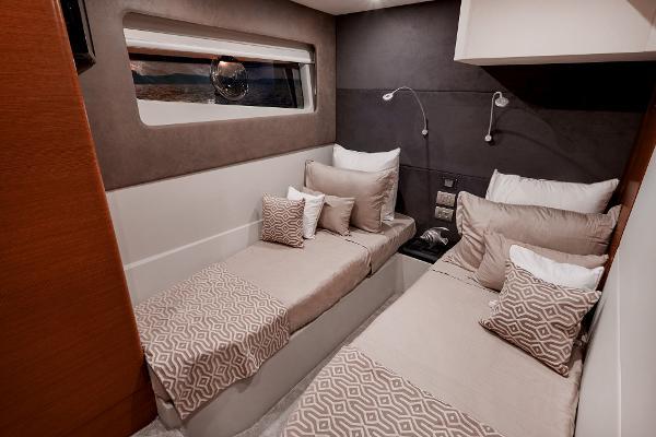 Slide: The Image of 2024 Schaefer 600 yacht cabin with twin beds and modern decor. - 27