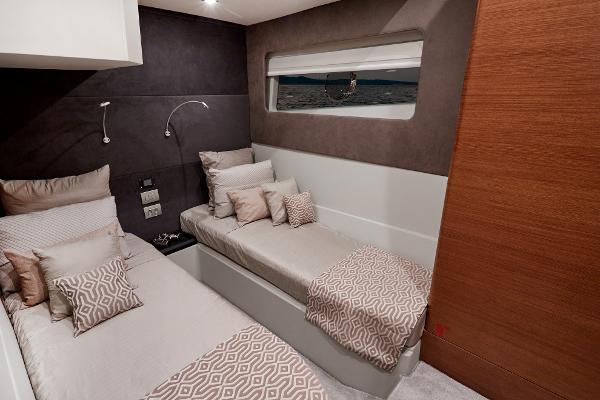 Slide: The Image of 2024 Schaefer 600 yacht cabin with twin beds and modern decor. - 28