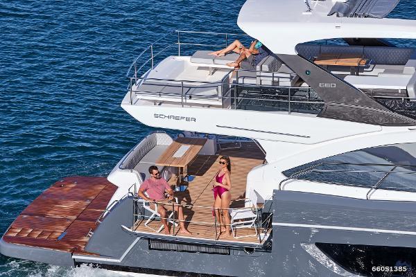 Slide: The Image of 2024 Schaefer 600 yacht with people relaxing on deck in the ocean. - 5