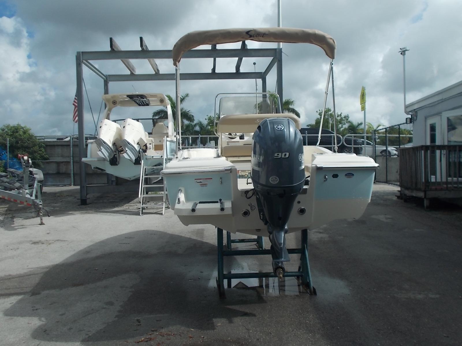 Slide: The Image of 2025 Scout 175 Sportfish boat with Yamaha 90 engine in a marina. - 11
