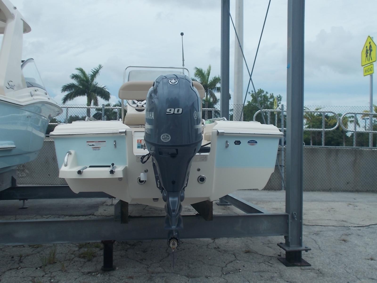 Slide: The Image of 2025 Scout 175 Sportfish boat with Yamaha 90 engine on a lift. - 2