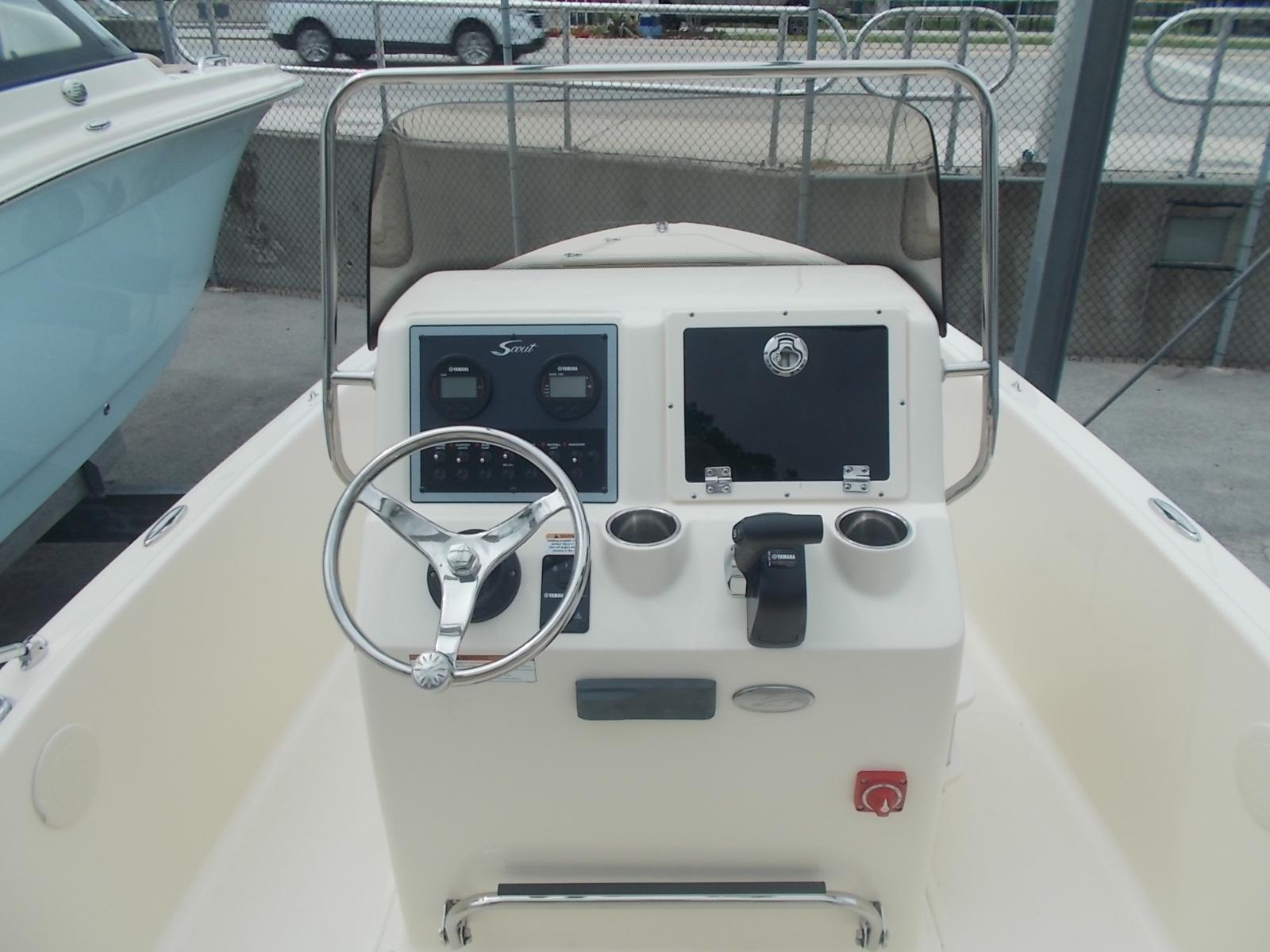 Slide: The Image of 2025 Scout 175 Sportfish boat console with steering wheel and controls. - 4