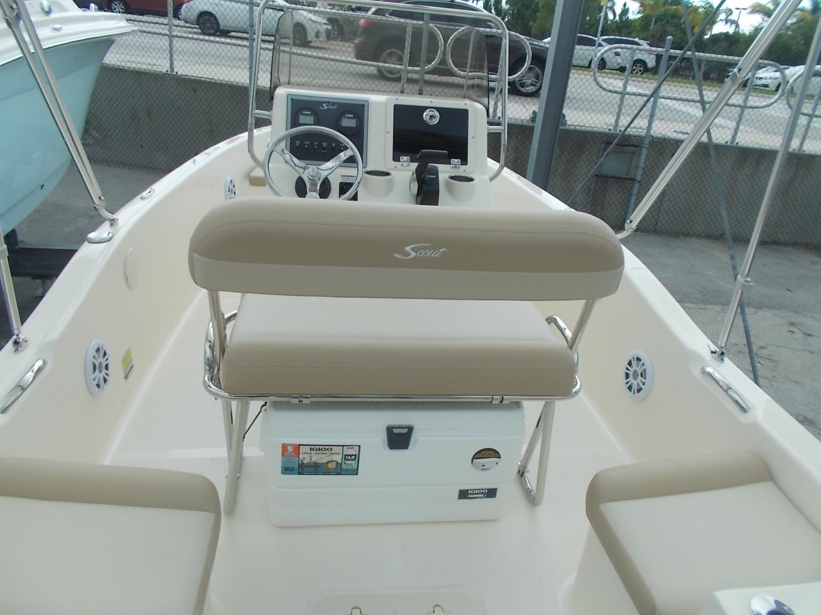 Slide: The Image of 2025 Scout 175 Sportfish boat interior with beige seating and steering console. - 8