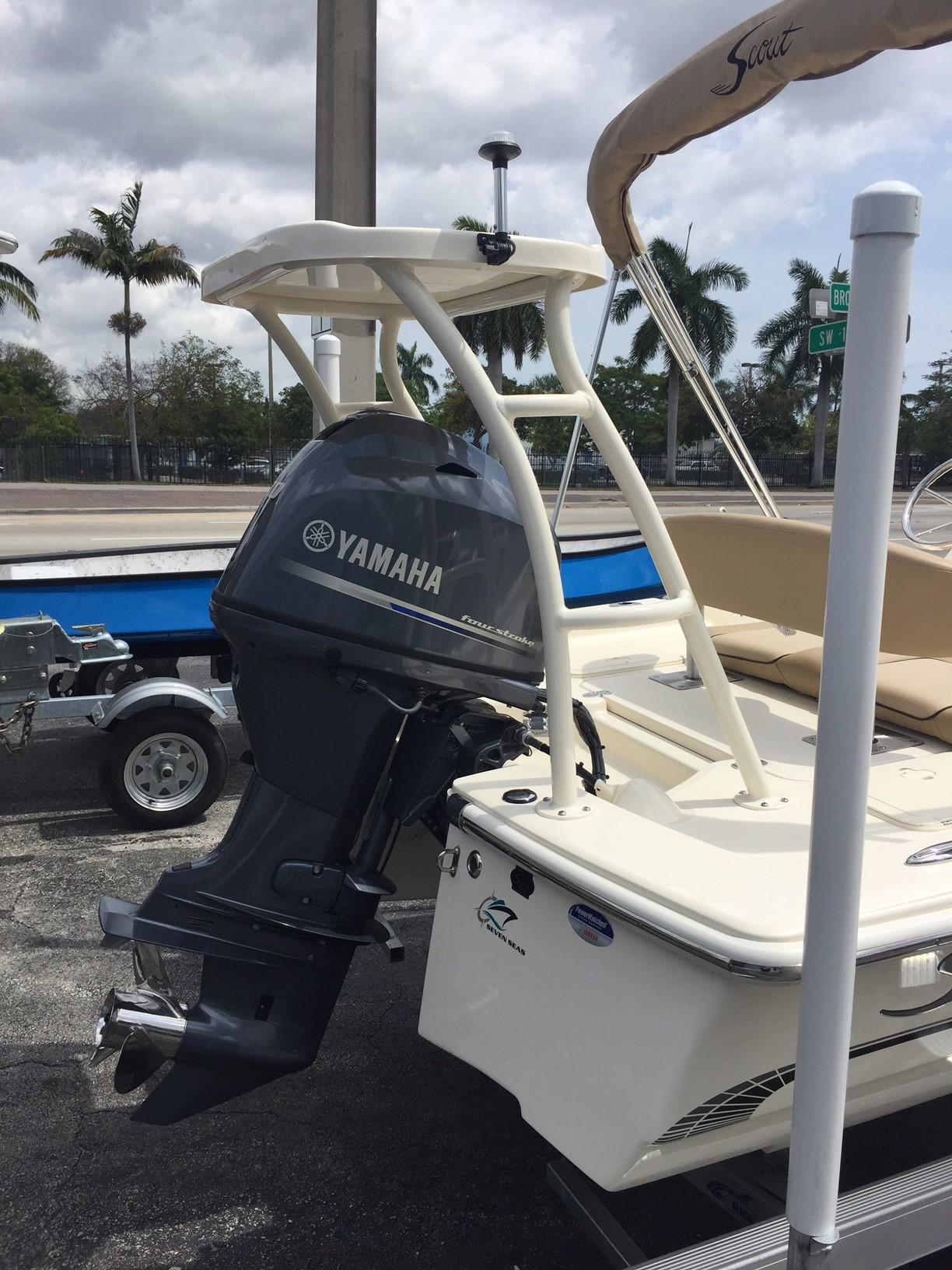 Slide: The Image of 2025 Scout 177 Sport boat with Yamaha outboard motor in a parking lot. - 2