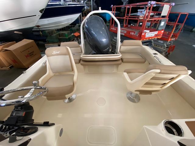 Slide: The Image of 2024 Scout 195 Sport Dorado boat interior with seating and steering wheel. - 10