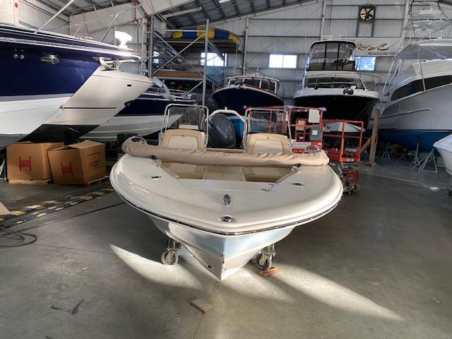 Slide: The Image of 2024 Scout 195 Sport Dorado boat in a storage facility with other boats. - 2