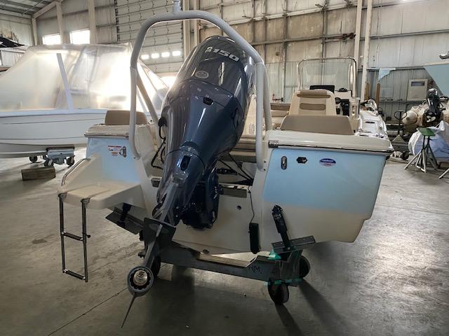 Slide: The Image of 2024 Scout 195 Sport Dorado boat with outboard motor in a storage facility. - 3