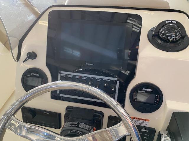 Slide: The Image of 2024 Scout 195 Sport Dorado boat dashboard with Garmin display and Yamaha gauges. - 4