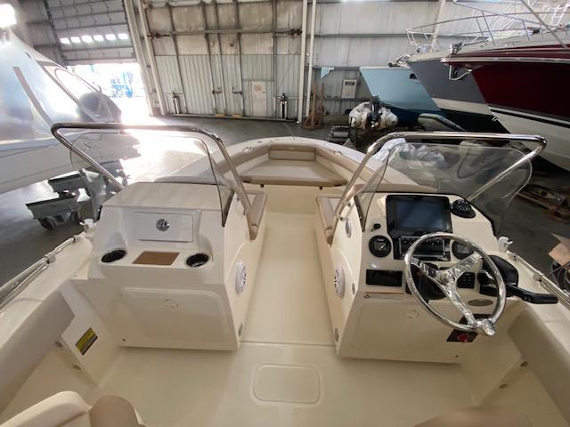 Slide: The Image of 2024 Scout 195 Sport Dorado boat interior with dual consoles and steering wheel. - 6