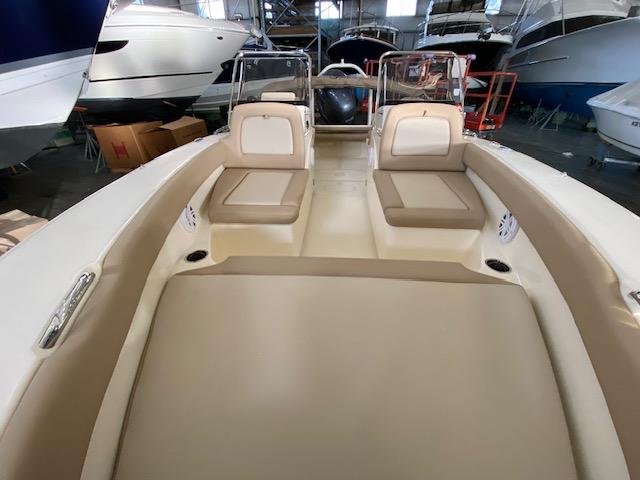 Slide: The Image of 2024 Scout 195 Sport Dorado boat interior with beige seating in a showroom. - 9