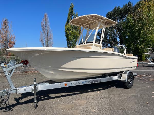 Slide: The Image of 2024 Scout 195 Sportfish boat on trailer in outdoor setting. - 0