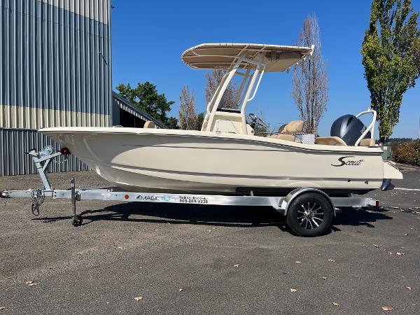 Slide: The Image of 2024 Scout 195 Sportfish boat on a trailer, parked outdoors. - 1