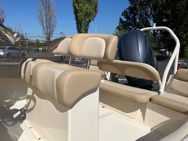 Slide: The Image of 2024 Scout 195 Sportfish boat interior with beige seating and outboard motor. - 7