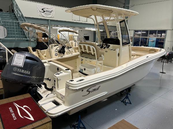 Slide: The Image of 2024 Scout 215 XSF boat with Yamaha engine on display in showroom. - 0