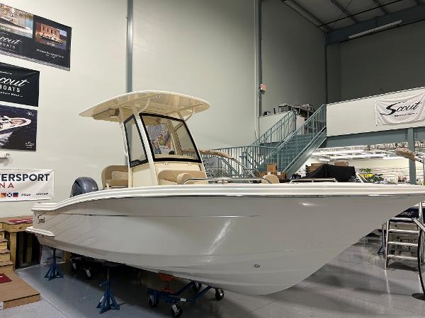 Slide: The Image of 2024 Scout 215 XSF boat displayed indoors. - 1