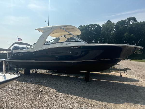 Slide: The Image of 2014 Scout 275 Dorado boat on display outdoors, side view. - 1
