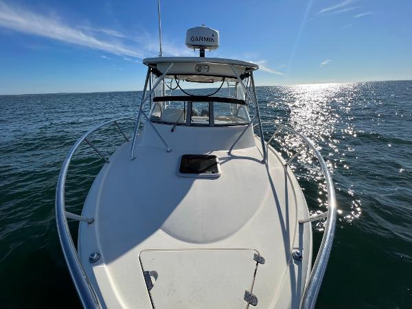 Slide: The Image of 2004 Scout 280 Abaco boat on open water, sunny day, Garmin radar visible. - 6