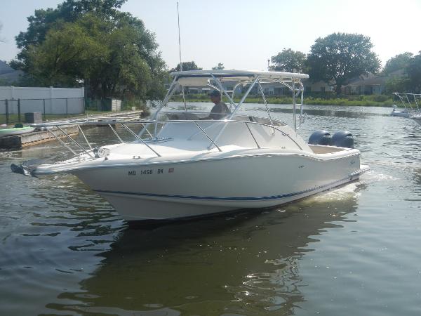 Slide: The Image of 2001 Scout 282 Abaco boat cruising on a calm river with trees in the background. - 1